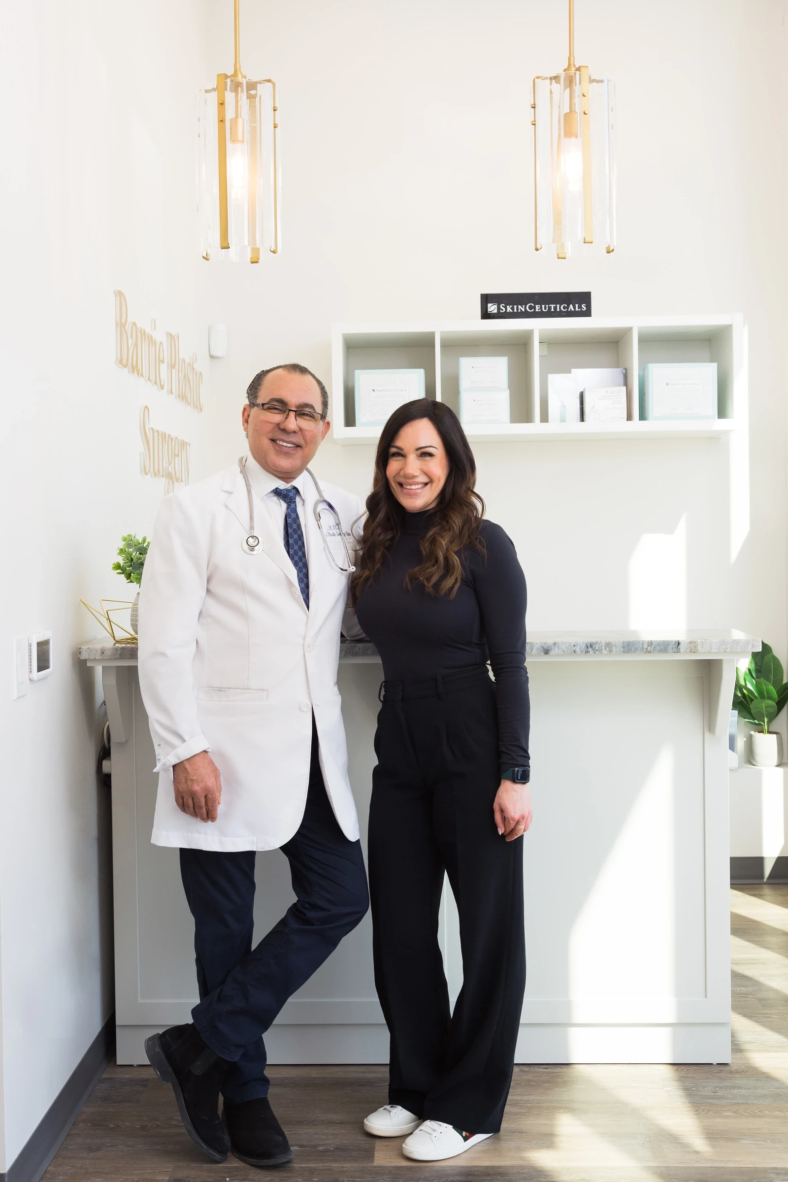 Dr. Kamal Tumi with a member of the team at the Barrie Plastic Surgery front desk